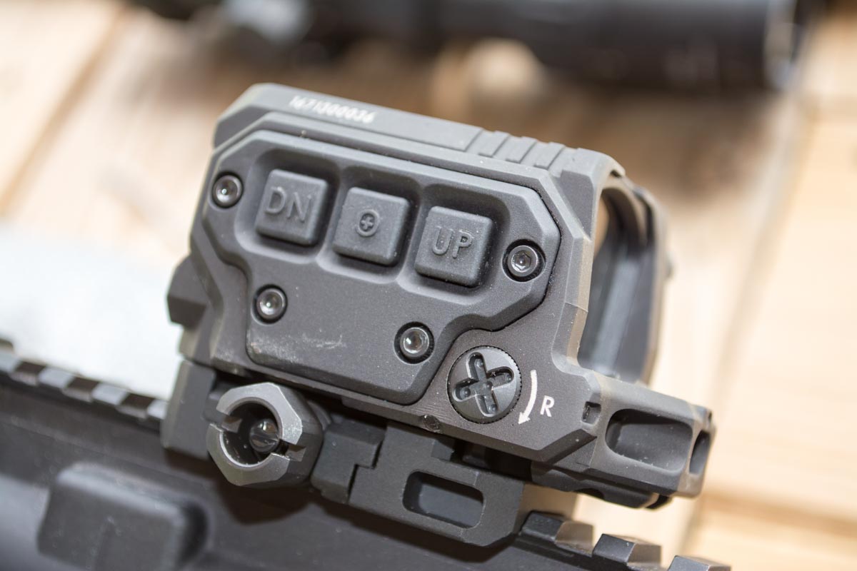 The center button is the on-off switch and also switched between the single and four-dot reticles. The other two raise and lower dot intensity. 