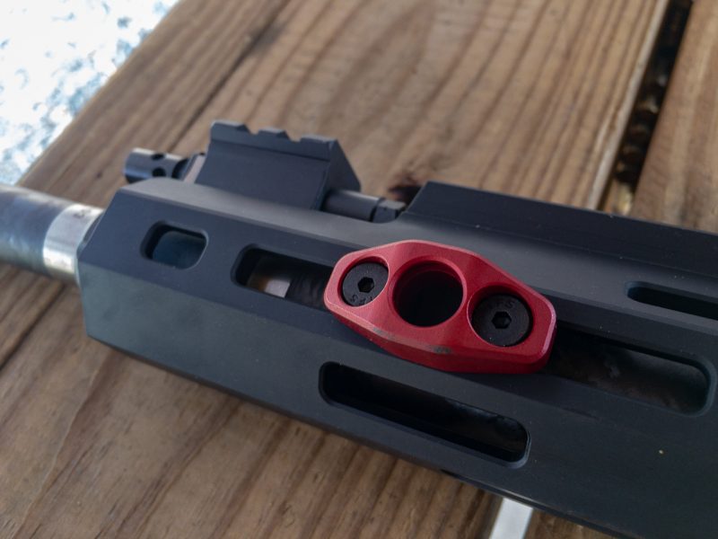 The free-floated handguard is MLOK compatible and comes with this sling attachment adapter. 