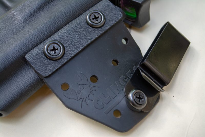 Here's the magic. The front belt clip is attached to the holster body with a flexible rubber or leather hinge. That allows the rigid back wing to draw the grip in close. 