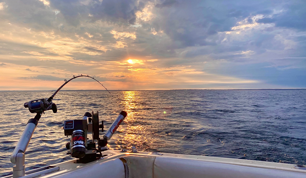 Fishing rods and reels on boat with lure on Lake Michigan Stock